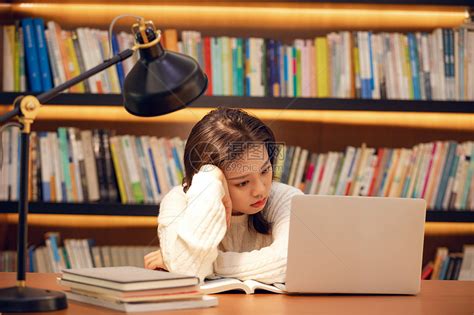 年轻女士在图书馆用笔记本电脑学习高清图片下载-正版图片501562431-摄图网