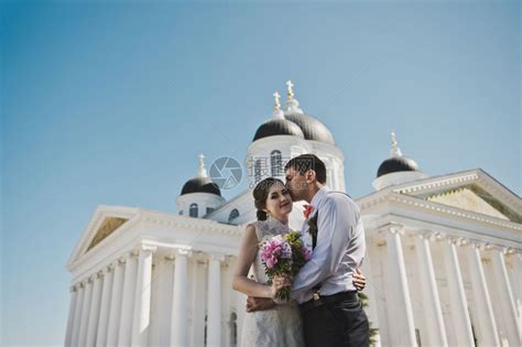 夫妻们站在白色柱子前丈夫和妻拥抱着3798教堂的背景高清图片下载-正版图片307148260-摄图网
