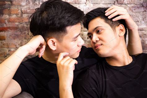 Asian gay couple looking at each other together at vintage home ...