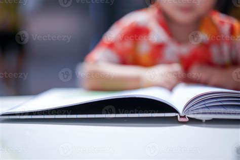 Asian girl kid concentrated read a book, close up at the book. 8998524 ...