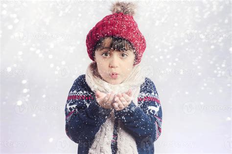 little child blows snow from hands in christmas 6156198 Stock Photo at ...
