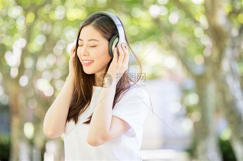 树林下戴耳机听音乐的甜美女生高清图片下载-正版图片500635996-摄图网