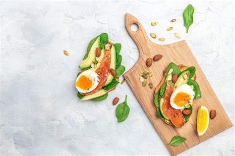 Premium Photo | Toast with avocadoo salmon and spinach nuts sunflower ...