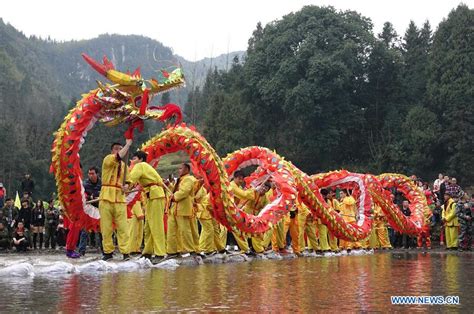 Dragon dancers march in a parade. The dragon dance is usually the ...