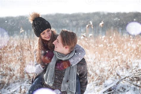 christmas happy couple in love embrace in snowy winter cold forest ...