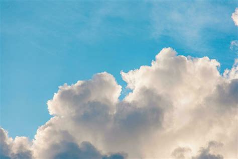 various shapes of clouds on different levels of blue background ...