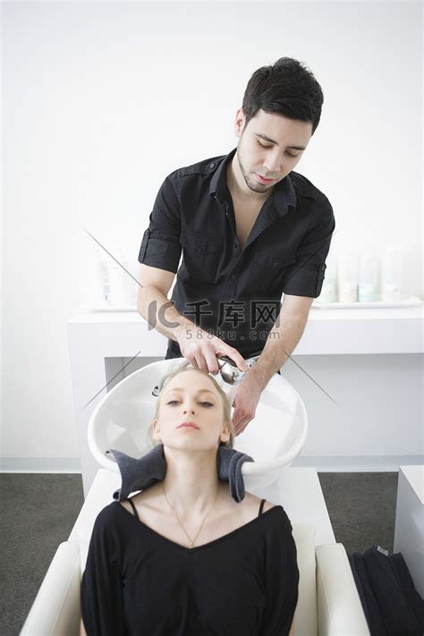 男子在理发店为顾客洗头高清摄影大图-千库网