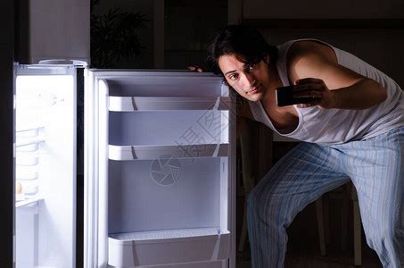 晚上睡在露天冰箱附近的地板上的男高清图片下载-正版图片502632954-摄图网
