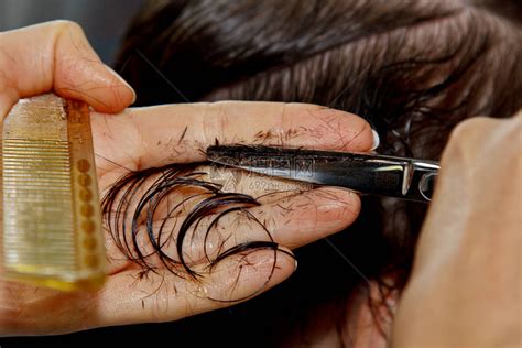 美发师的特写镜头在沙龙里剪掉客户湿漉的棕色头发理发师剪女人用剪刀头高清图片下载-正版图片506367185-摄图网