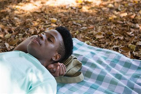 Young Man Sleeping On A Picnic Blanket Photo Background And Picture For ...