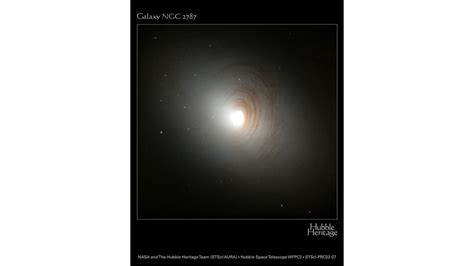 Tightly Wound Arms of Dust Encircle Nucleus of Galaxy NGC 2787 | HubbleSite