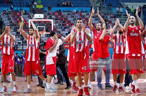 The Olympiacos Piraeus players celebrate victory at the end of the ...
