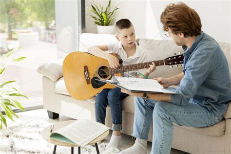 辅导男孩在家学习吉他男闲暇学生高清图片下载-正版图片307853659-摄图网
