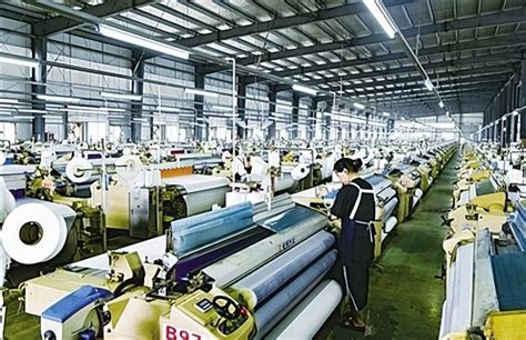 7月25日，邓州市嘉兴化纤纺织及服装生产基地车间里，工人正加紧生产。张峰 摄