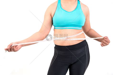 胖女人测量她的腰围肥胖的肚子高清图片下载-正版图片502970785-摄图网