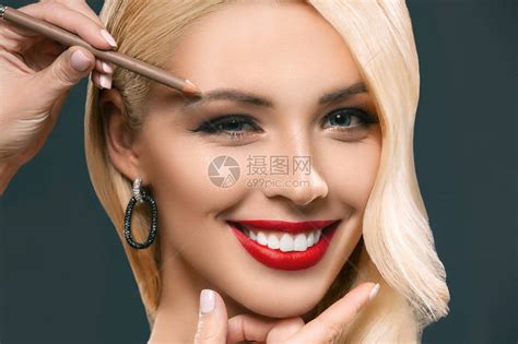 美丽的微笑着的美丽女人用眉毛化妆在灰高清图片下载-正版图片503353339-摄图网