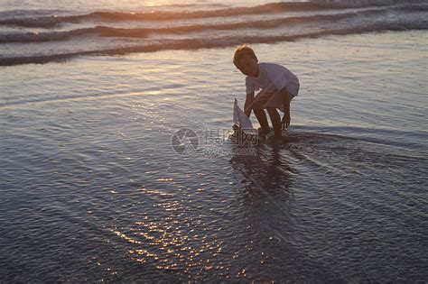 小男孩在水里玩玩具船高清图片下载-正版图片501841392-摄图网