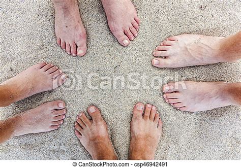 Feet of family at the beach. | CanStock