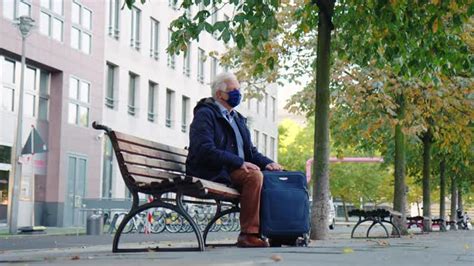 一名游客向一位坐在长凳上的老人问路—高清视频下载、购买_视觉中国视频素材中心