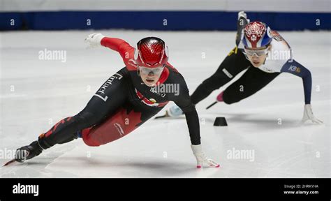 Canadian speedskater Kim Boutin (left) skates to a first-place finish ...