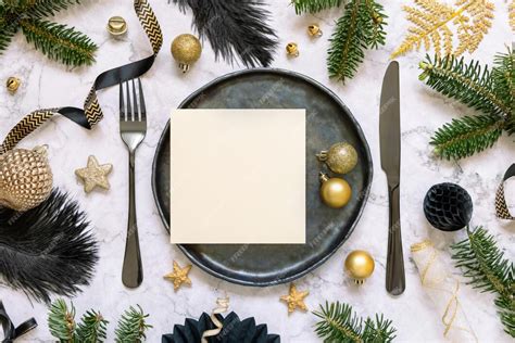 Premium Photo | Black and golden christmas table setting with a card ...