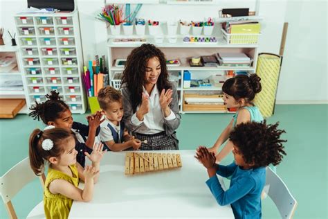 Teacher teaching elementary kids with block play in class - Stock Photo ...